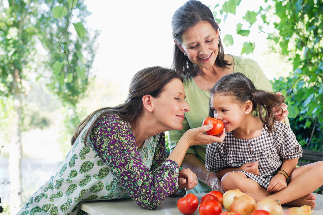 people smelling tomatoes
